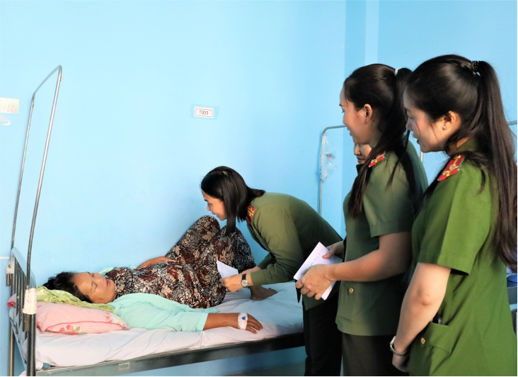 Đồng chí Trung tá Nguyễn Nhã Phương, Trưởng Ban Phụ nữ Công an tỉnh cùng các đồng chí hội viên đang ân cần thăm hỏi, tặng quà cho nữ bệnh nhân